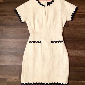 White sheath dress with navy scallop trim